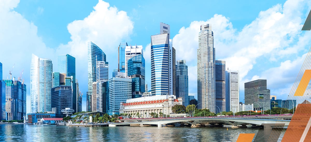 A skyline view of Singapore with buildings and the river in the foreground.